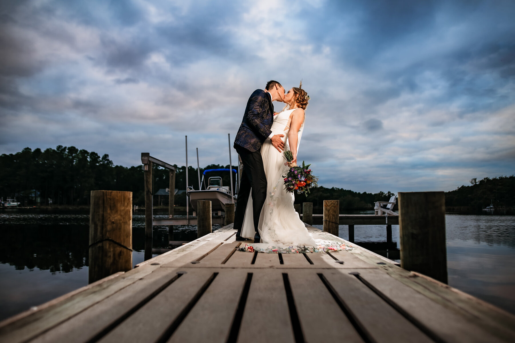 North Carolina Wedding Photography Couple kissing on a pier